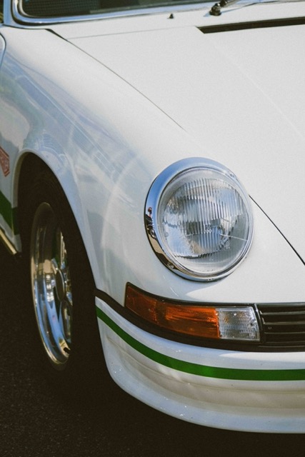 vertical-shot-of-a-white-vintage-car-parked-outdoor-Porsche 928