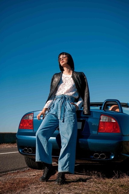 young-stylish-woman-with-a-haircut-standing-near-road-Porsche 928