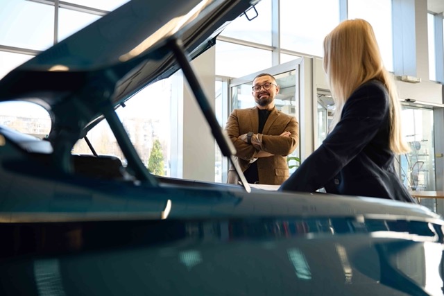 young-guy-looks-into-the-hood-of-a-car-Porsche 928